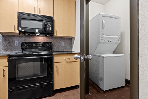 a kitchen with a refrigerator and a stove and a microwave a kitchen with a refrigerator and a stove and a microwave at The Millennium Towne Center Apartments, Louisiana